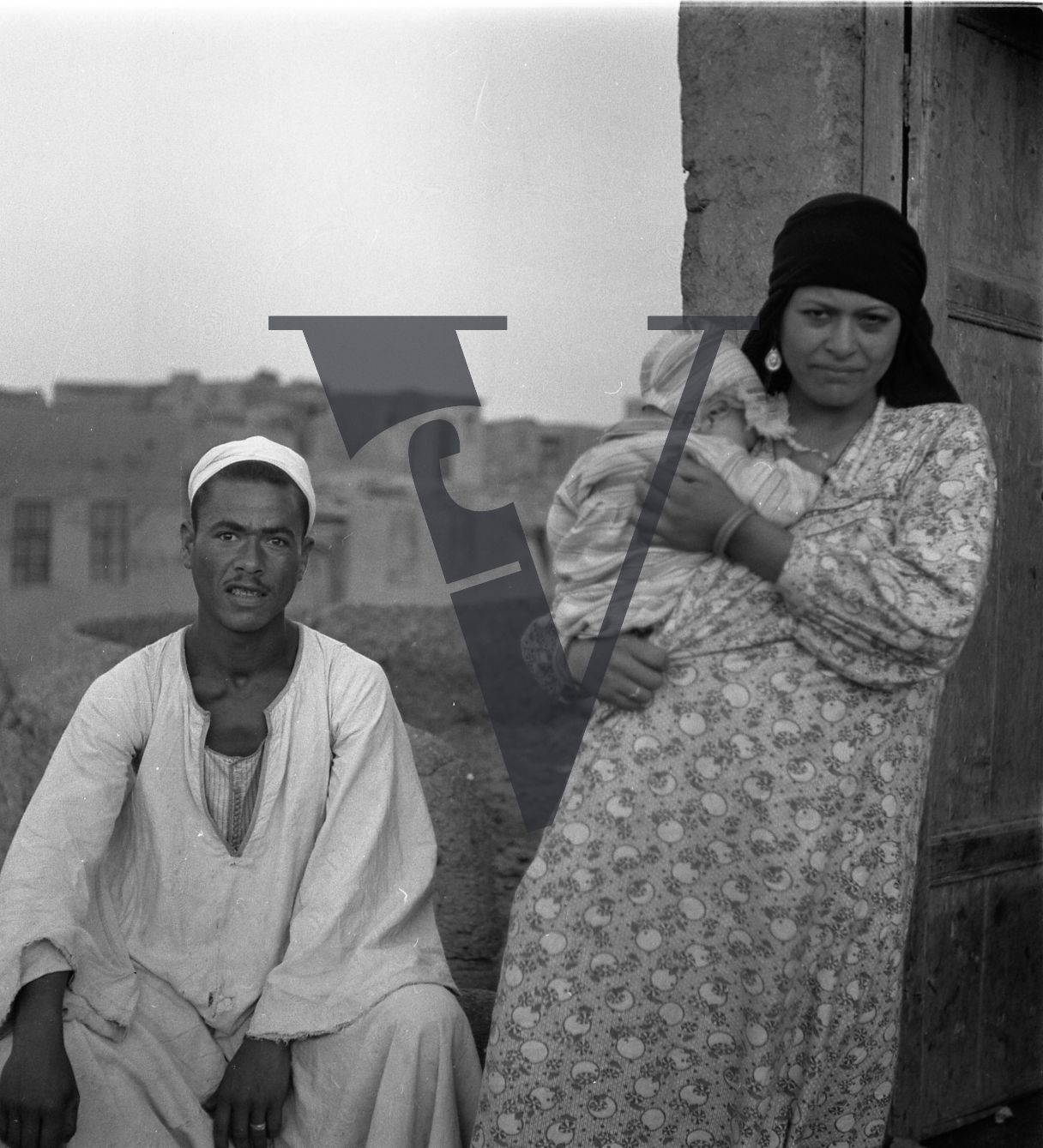 Harrania, Egypt, mother and father pose for camera.