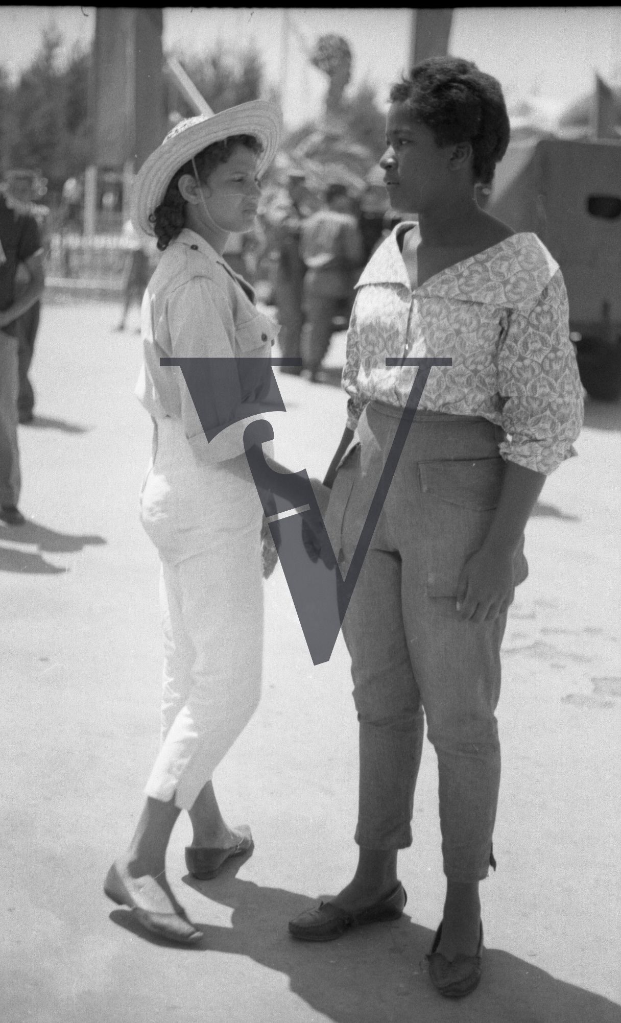 Cuba, Havana, May 1st, two women hold hands.