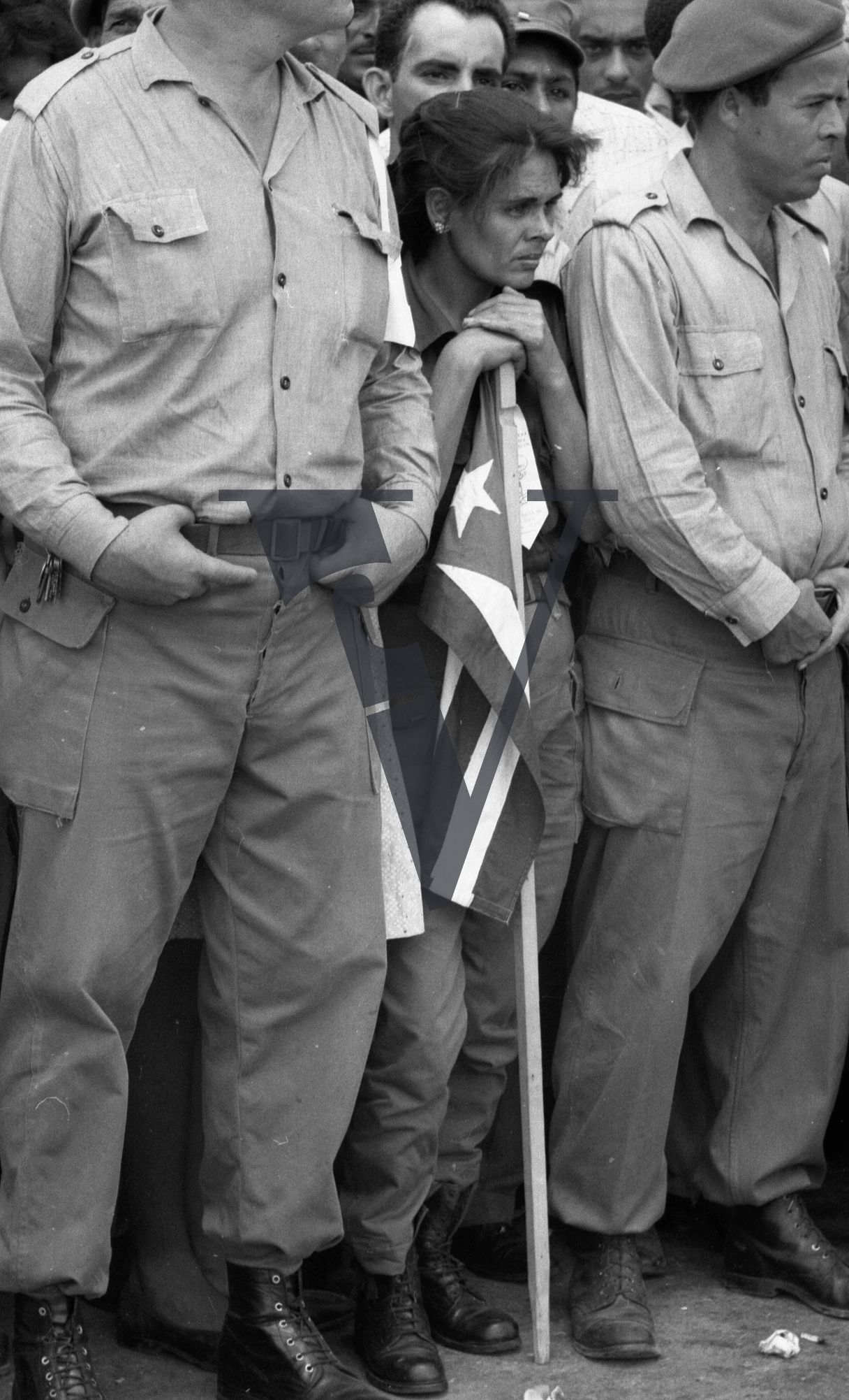 Cuba, Havana, May 1st, guard and woman holding flag.