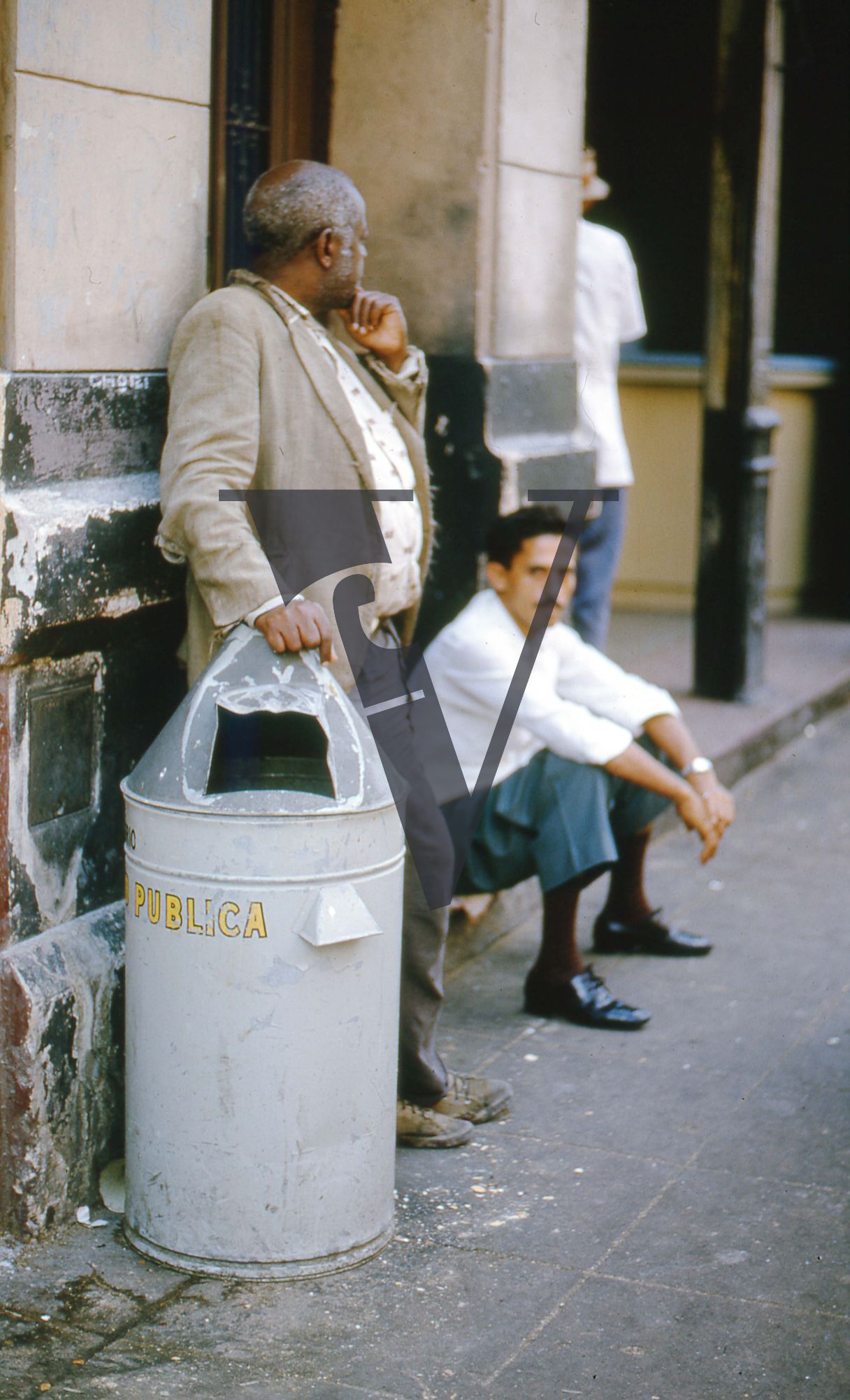 Cuba, Havana, May 1st, two men next to bin.