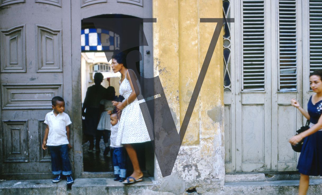 Cuba, Havana, May 1st, woman and children outside courtyard.