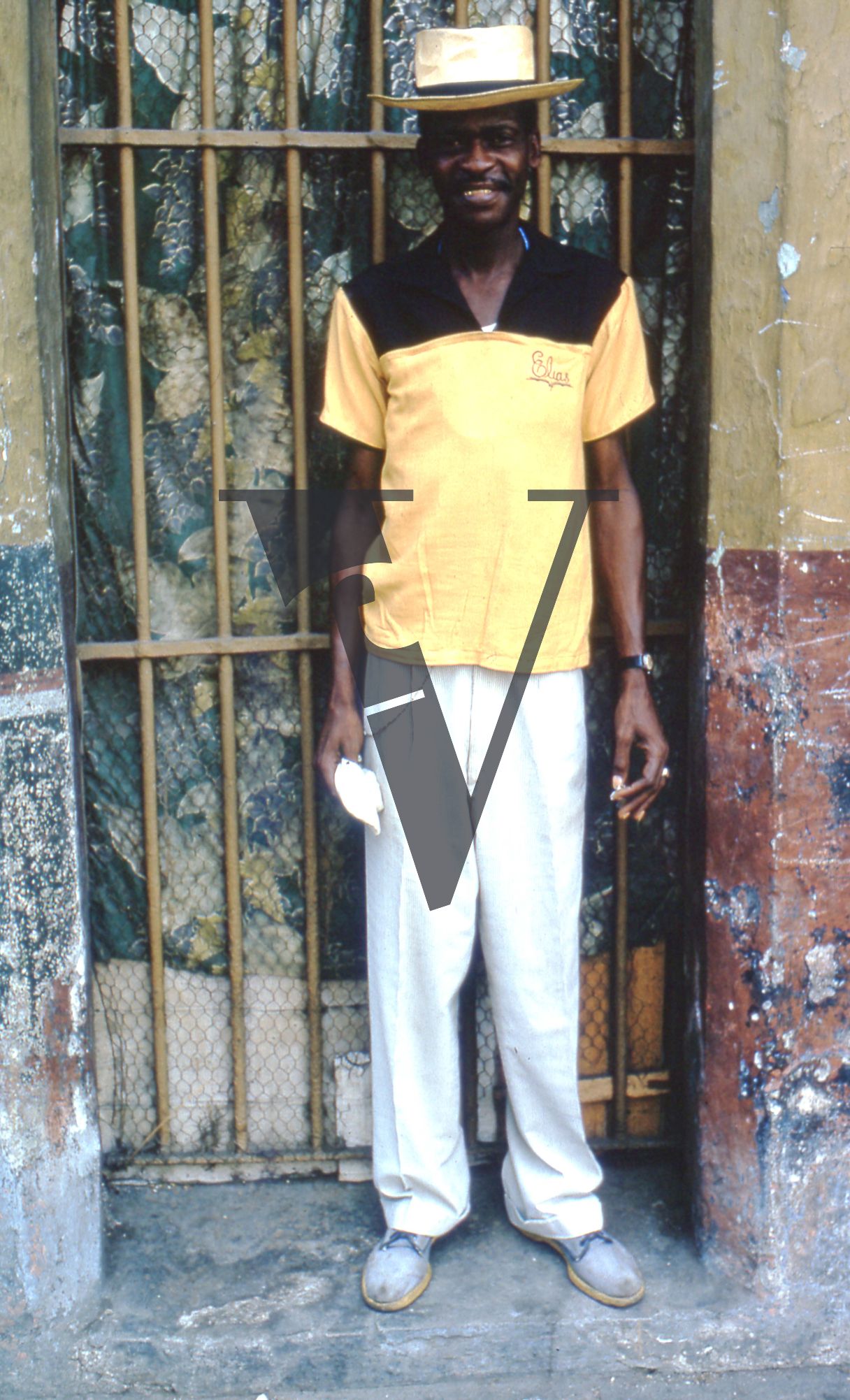 Cuba, Havana, May 1st, man in yellow and black smiling, portrait.