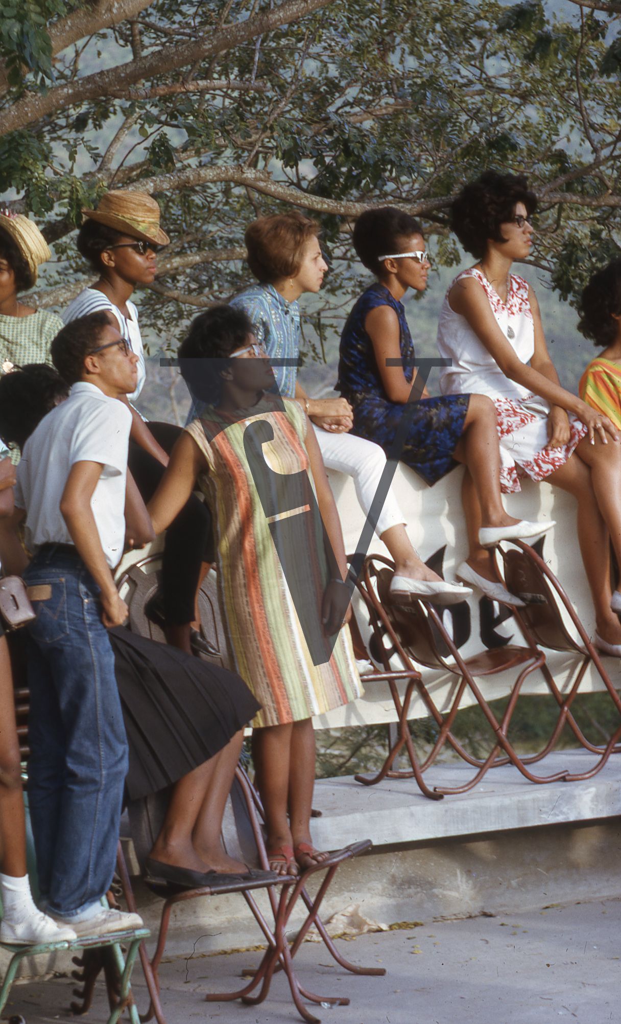 Jamaica, Group watching on in 60s fashions.