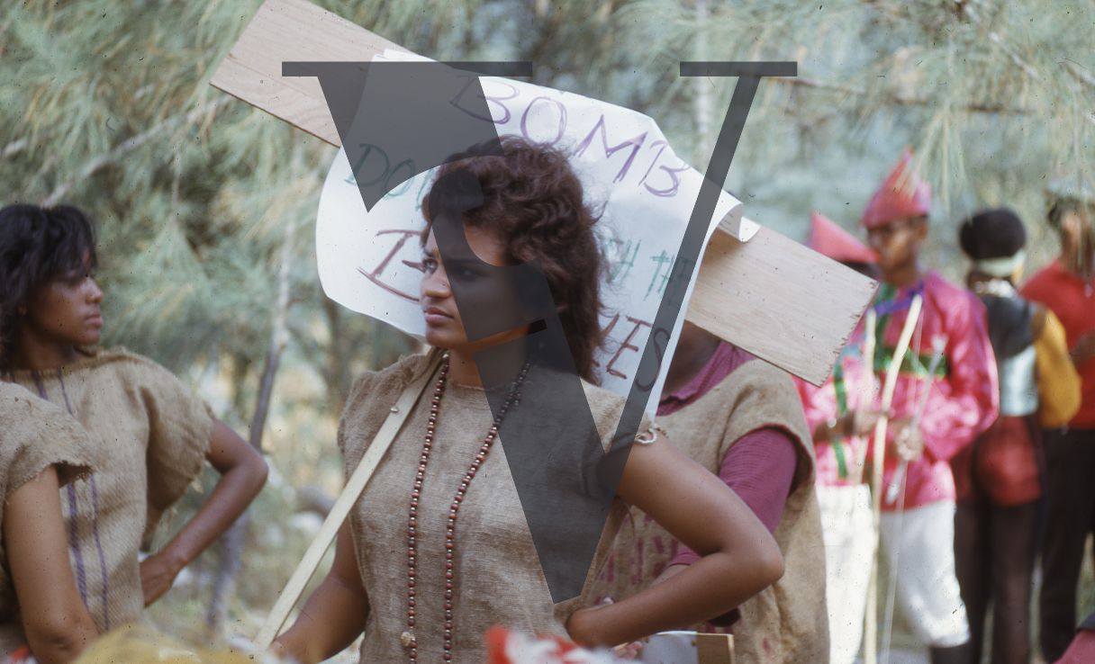 Jamaica, Jamaica, Woman at carnival holding signage.