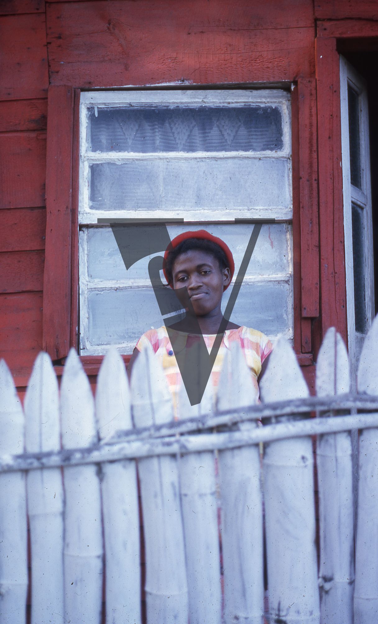 Jamaica, Woman over fence, portrait.