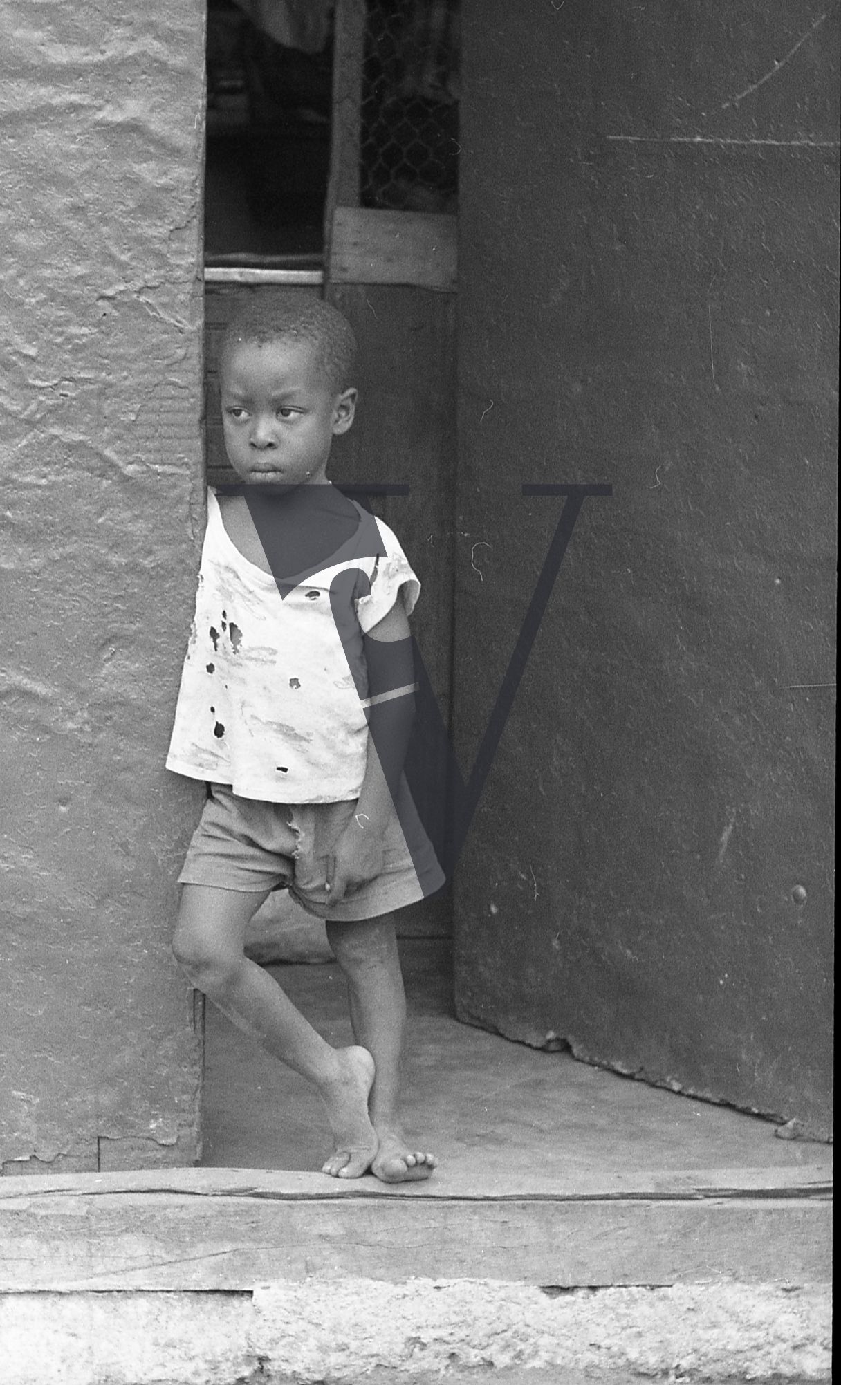 Jamaica, Boy looks out on to street, portrait.