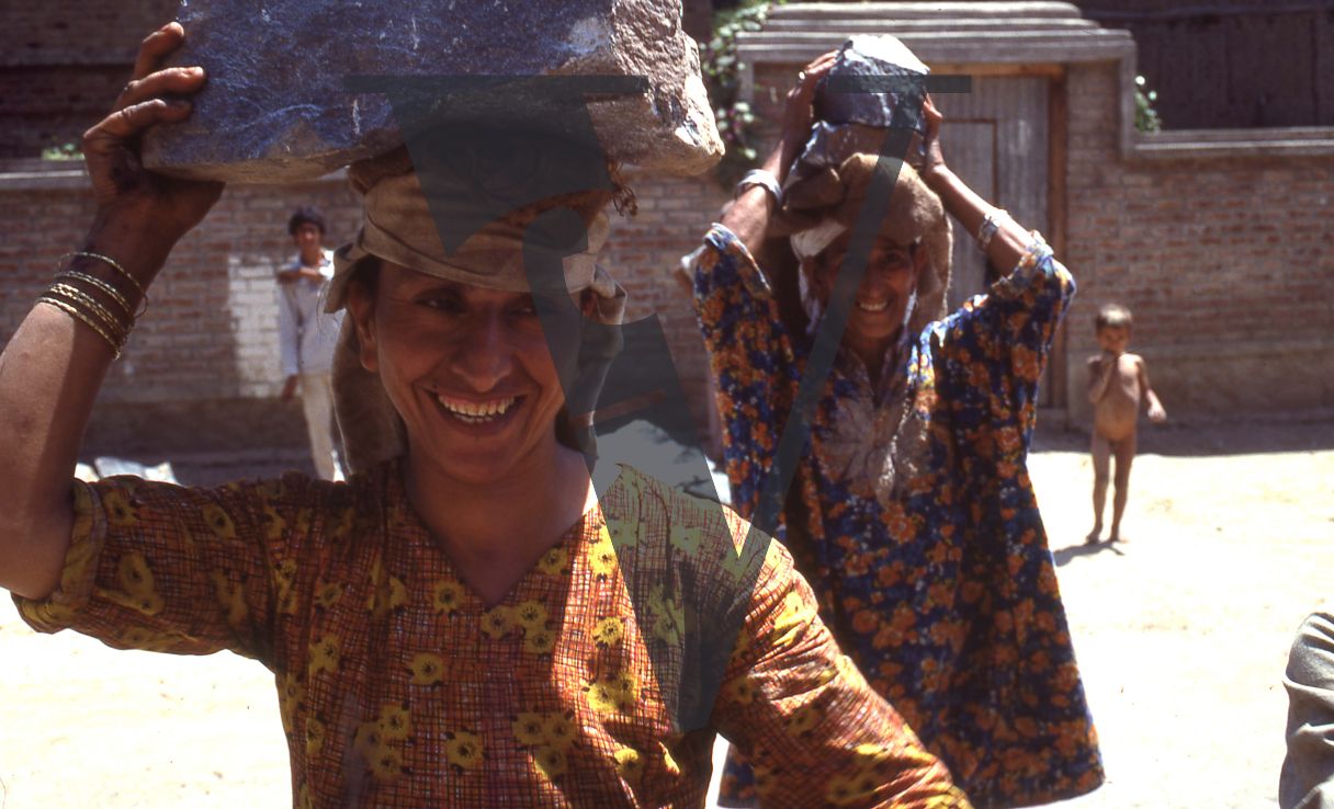 Kashmir, Srinagar women carrying things on head.