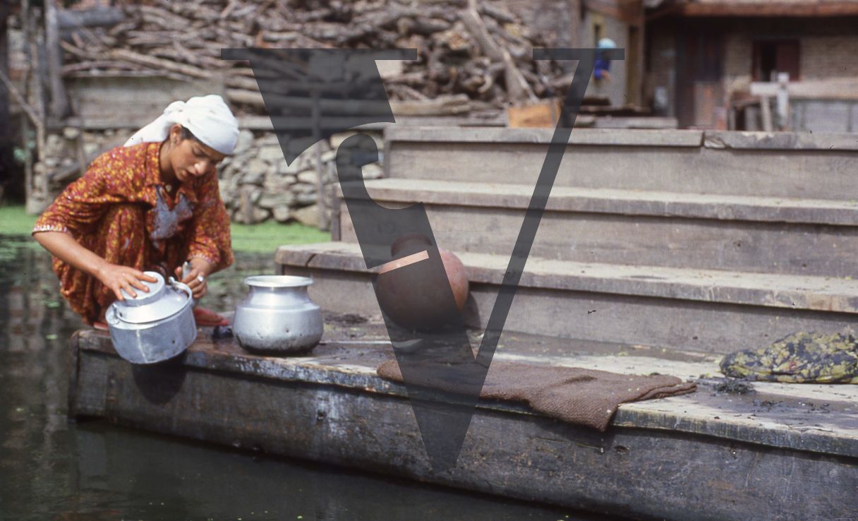 Kashmir, Woman washing pots.