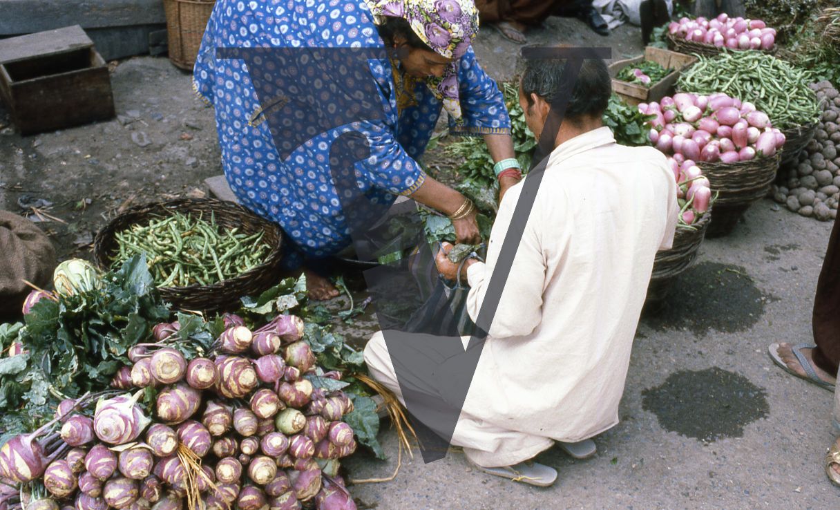 Kashmir, Man buying vegetables, roadside.