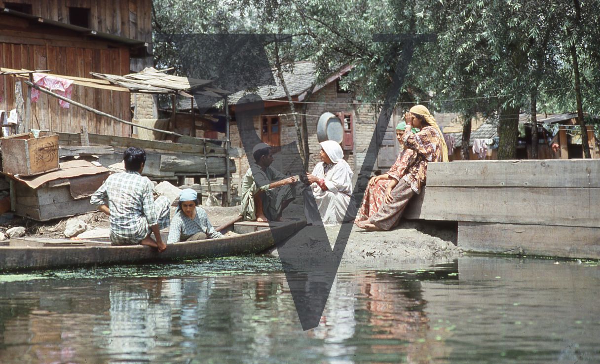 Kashmir, People in boat at shore.