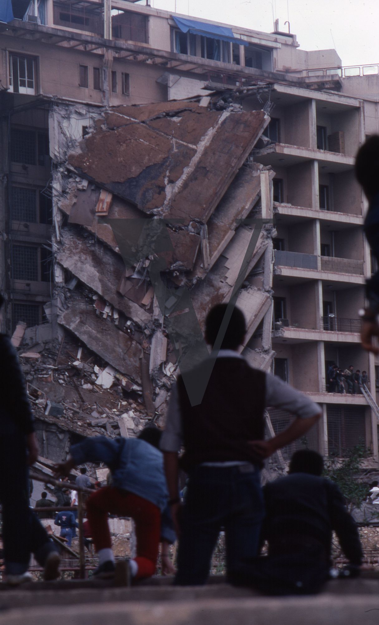 Lebanon, US Embassy Bombing, April 18, Beirut, collapsed embassy side-view, man watches on.