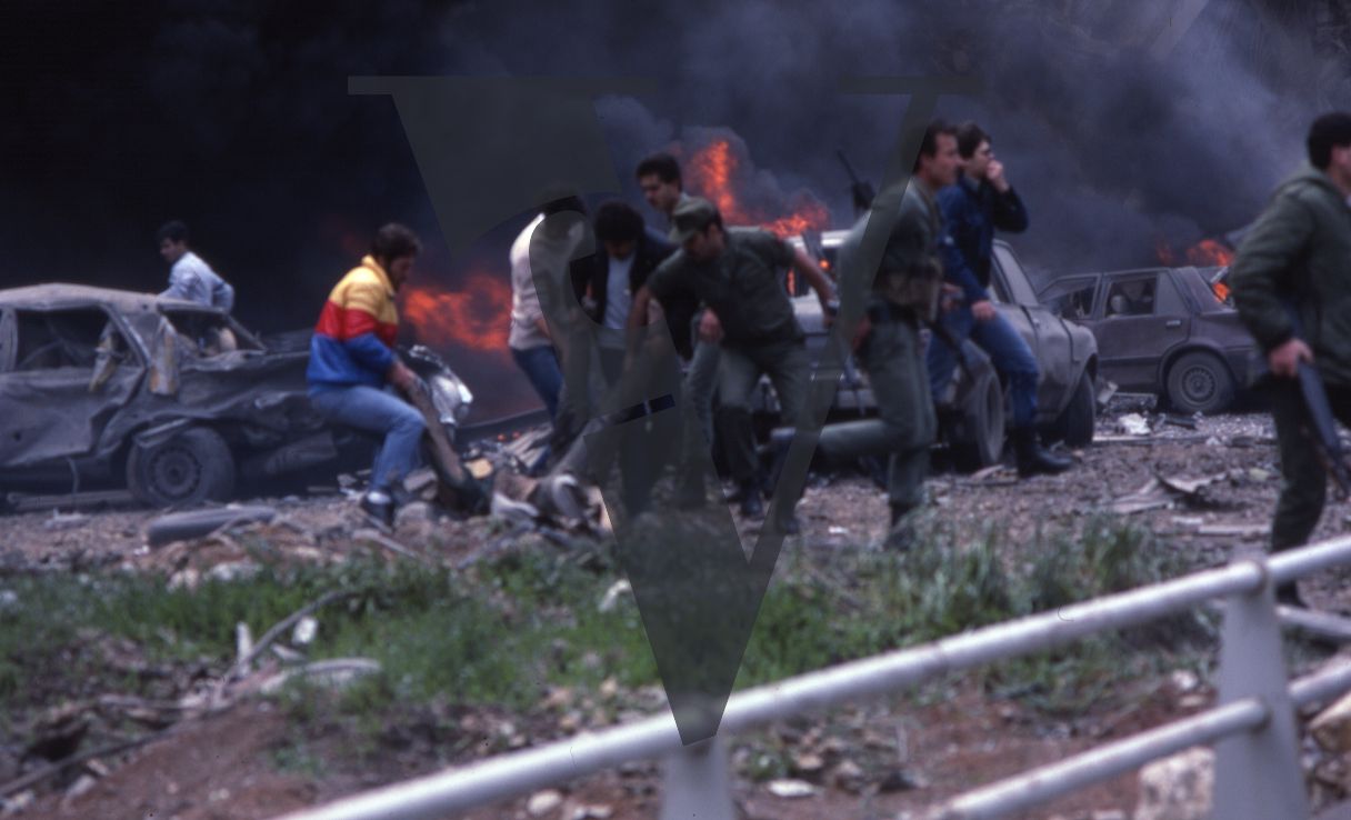 Lebanon, US Embassy Bombing, April 18, Beirut, civilians and soldiers help wounded body away from flames.