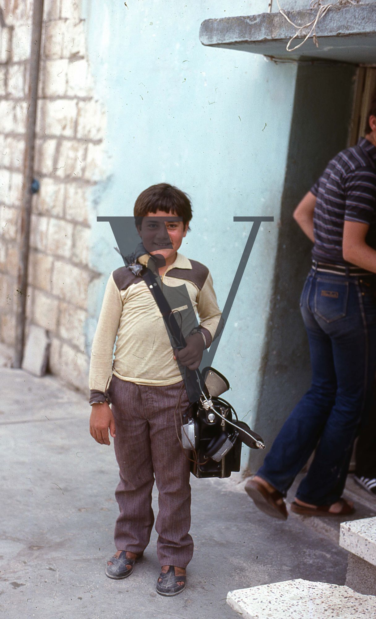 Lebanon, Beirut, Portrait, boy carrying Nagra recording device.