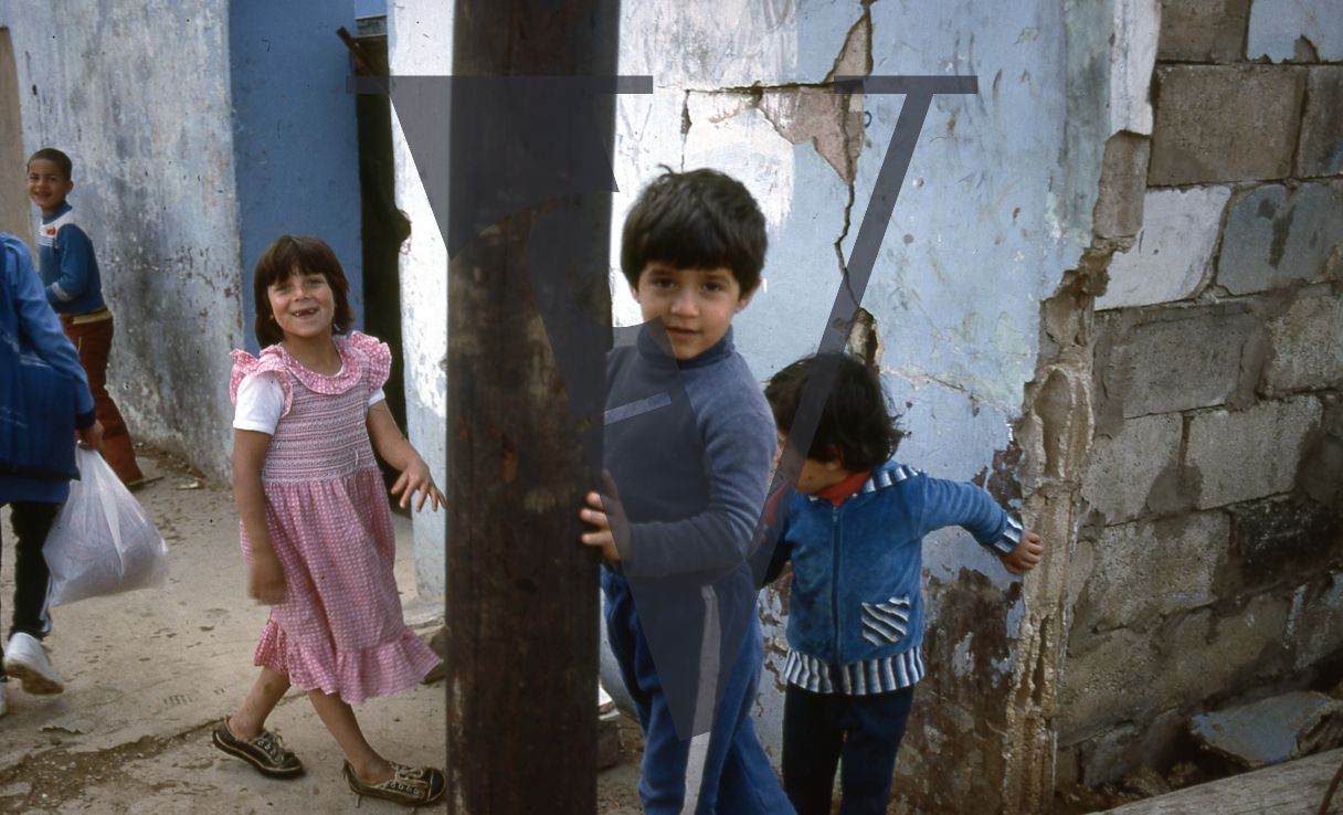 Lebanon, Refugee Camp, Sidon, children smile for camera, portrait.