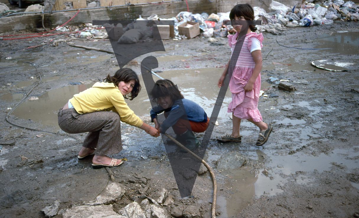 Lebanon, Beirut, boys and girl smile at camera, attend to water pipe.