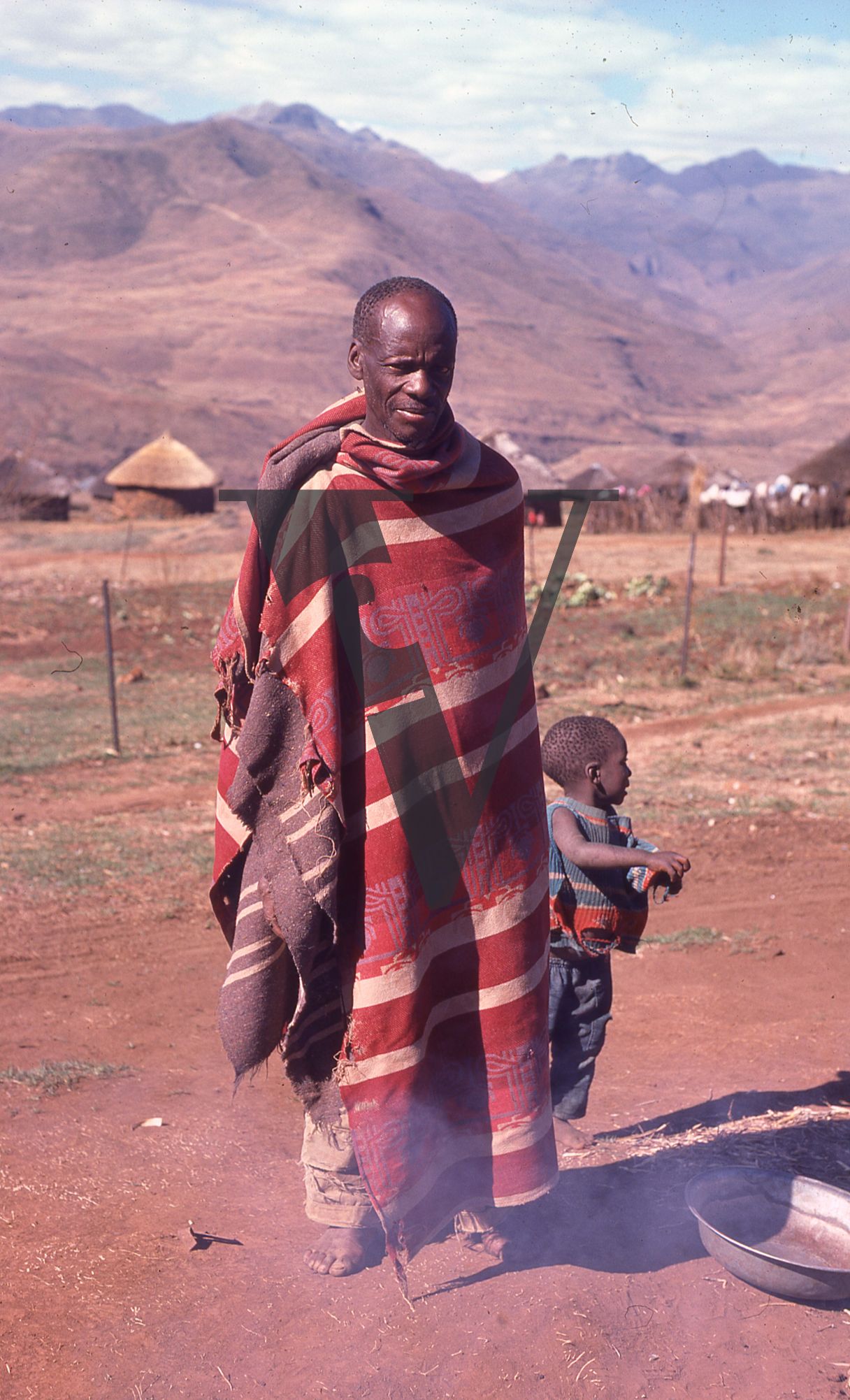 Lesotho, Handspun mohair farming community, man and child, stands at camera, portrait.