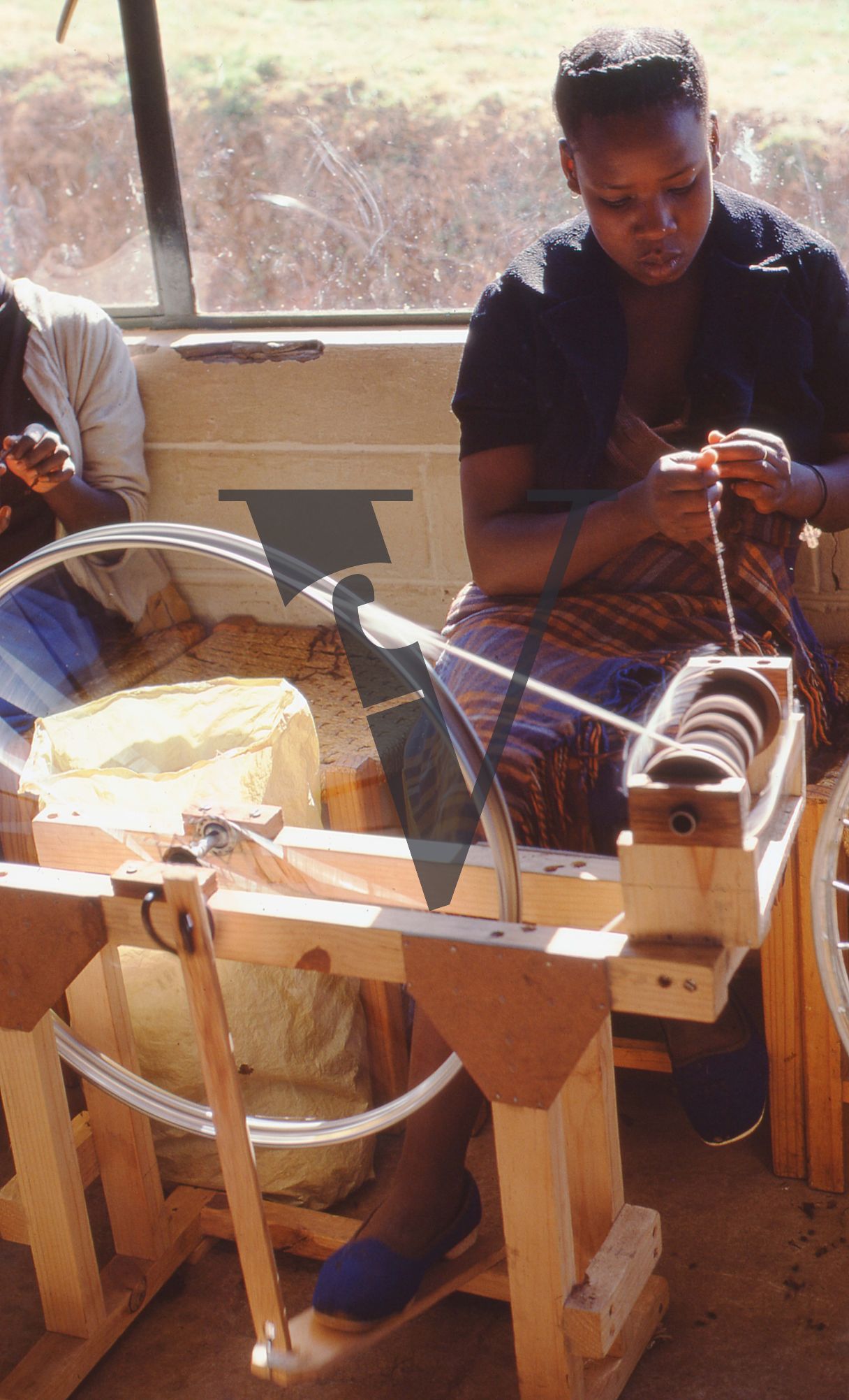Lesotho, Handspun mohair farming community, spinning wheel, woman at work.