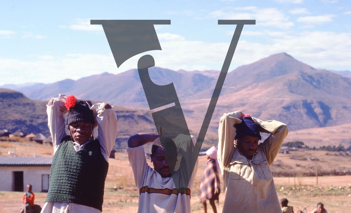 Lesotho, Handspun mohair farming community, three men about to swing tools, winnowing.