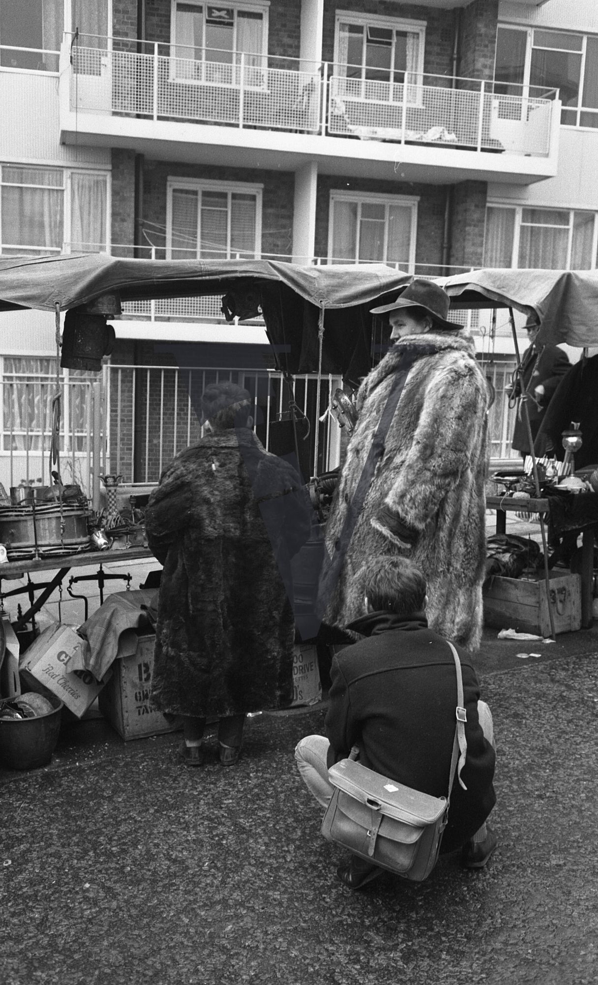 London, Sixties, street scenes, Portobello Road market, fur coat man and boy at stall.