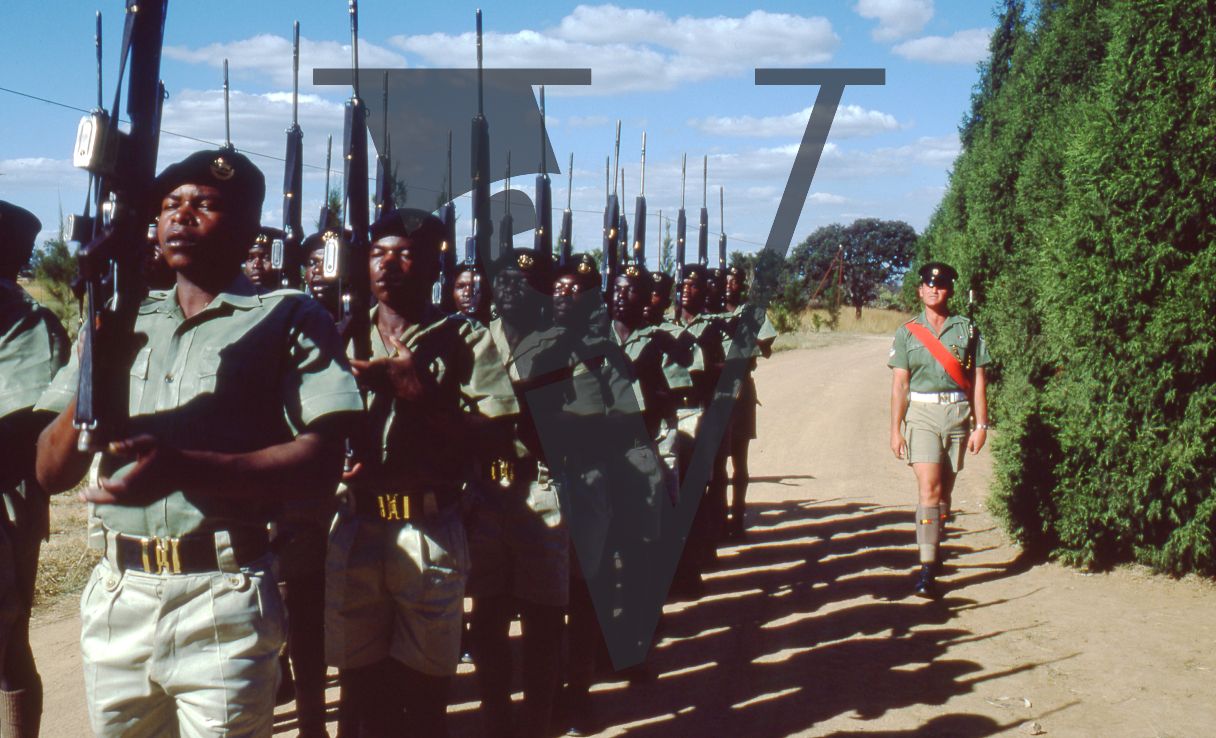 Rhodesia, Rhodesian African Rifles, sergeant, red sash, soldiers parading, wide shot.