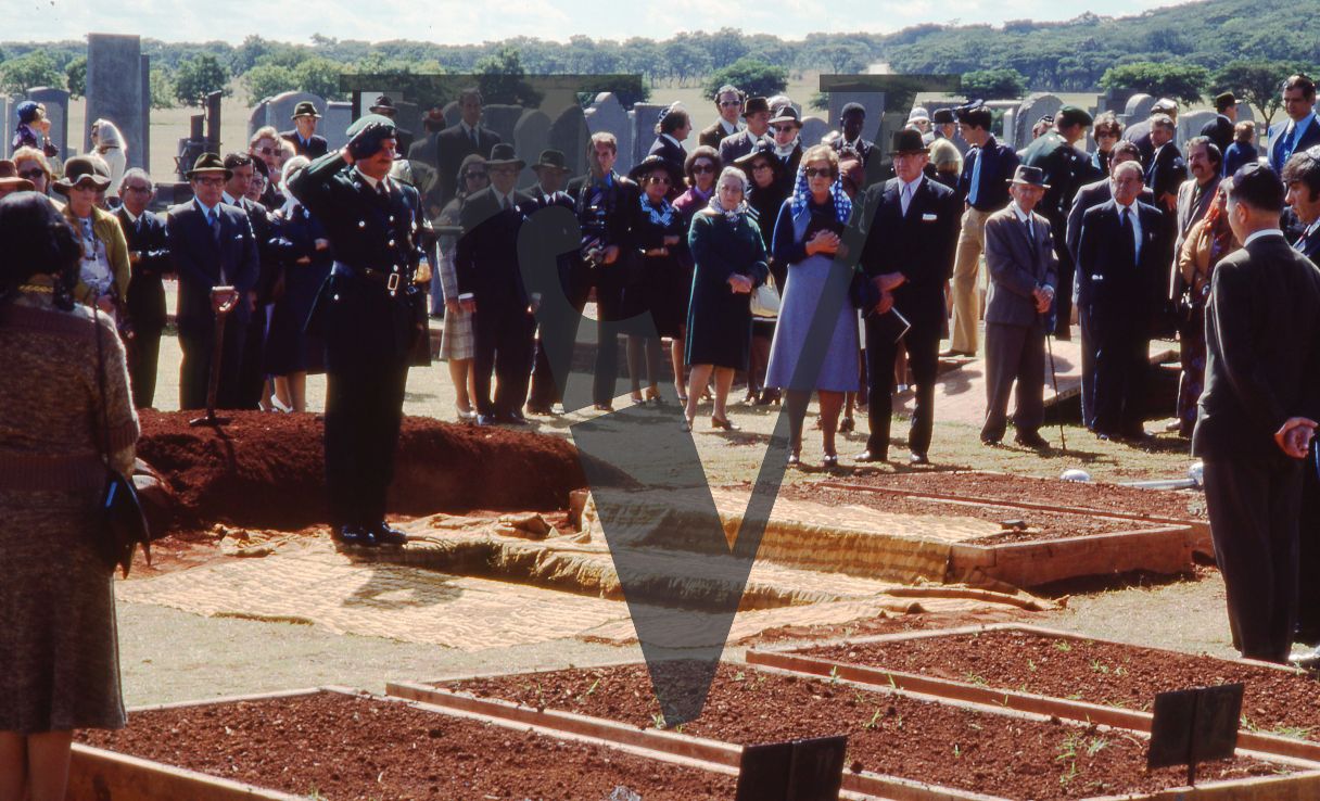 Rhodesia, Jewish funeral, mourners, ranked soldier saluting, wide shot.