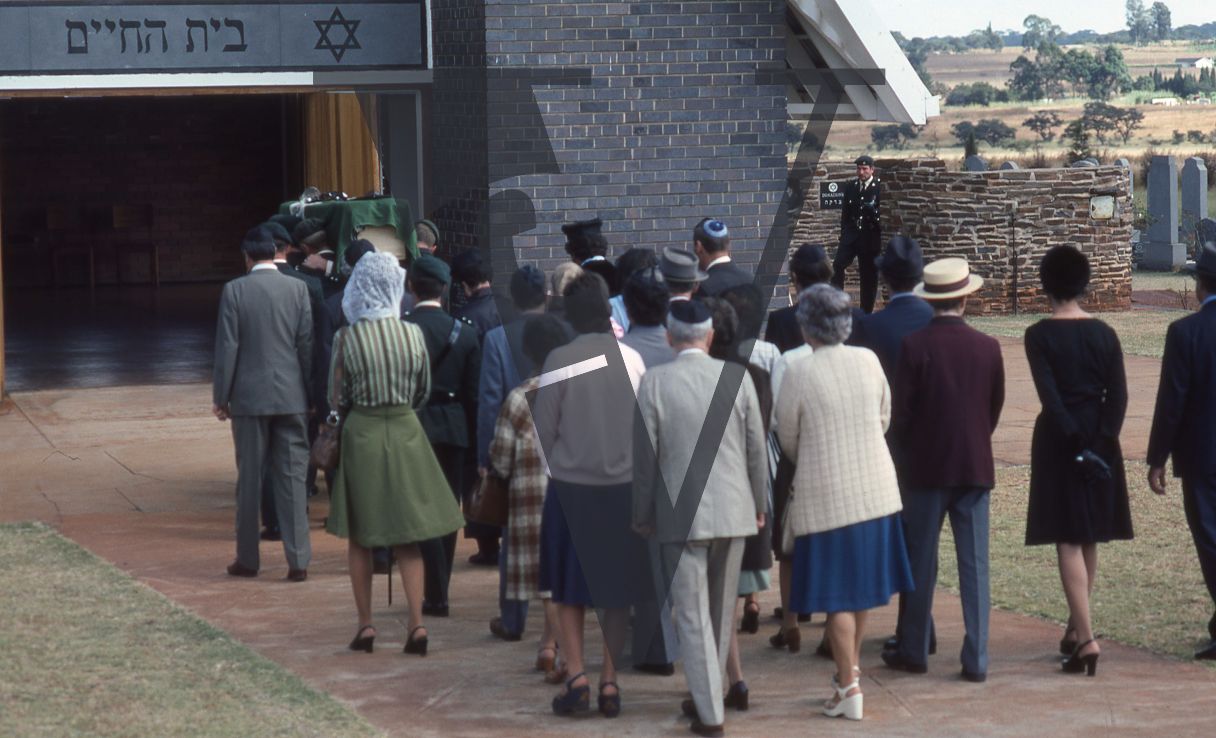 Rhodesia, Jewish funeral, mourners, pallbearers, soldiers, wide shot.