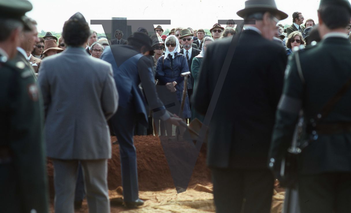 Rhodesia, Jewish funeral, mourners, filling the grave, wide shot.