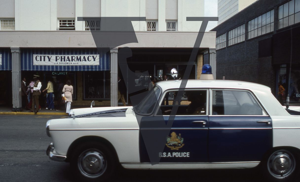 Rhodesia, Salisbury, street scene, British South Africa Police car, Peugeot 404.