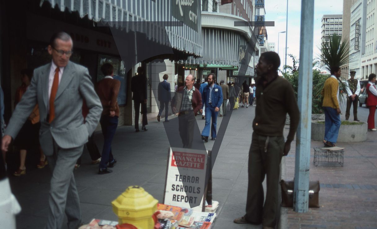Rhodesia, Salisbury, street scene, pedestrians, news sandwich board.