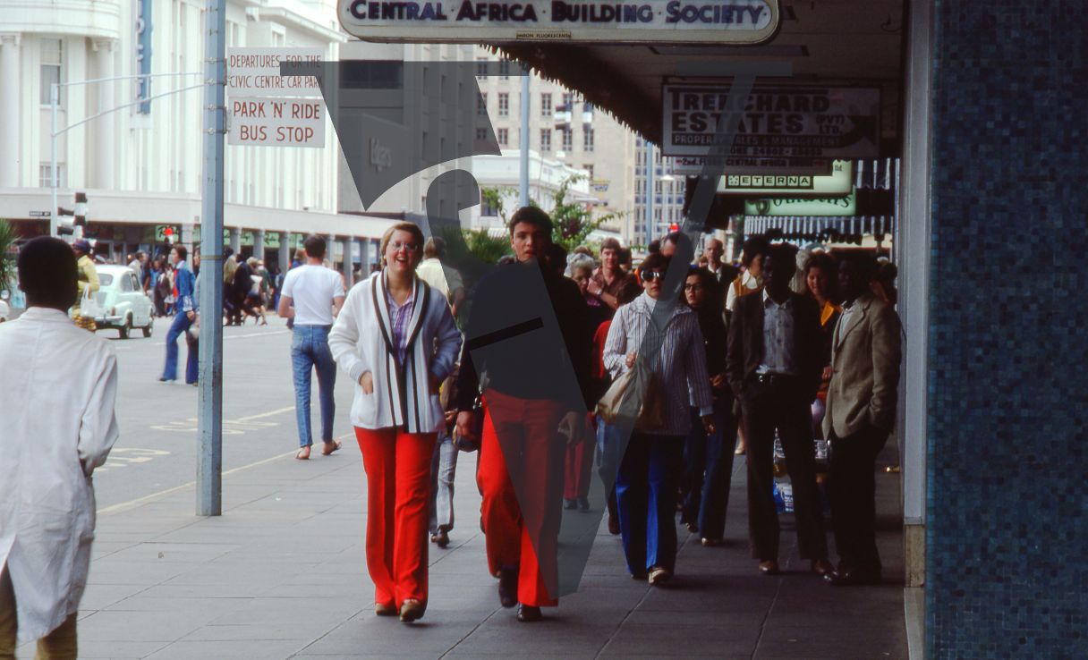 Rhodesia, Salisbury, street scene, pedestrians, red trousers.