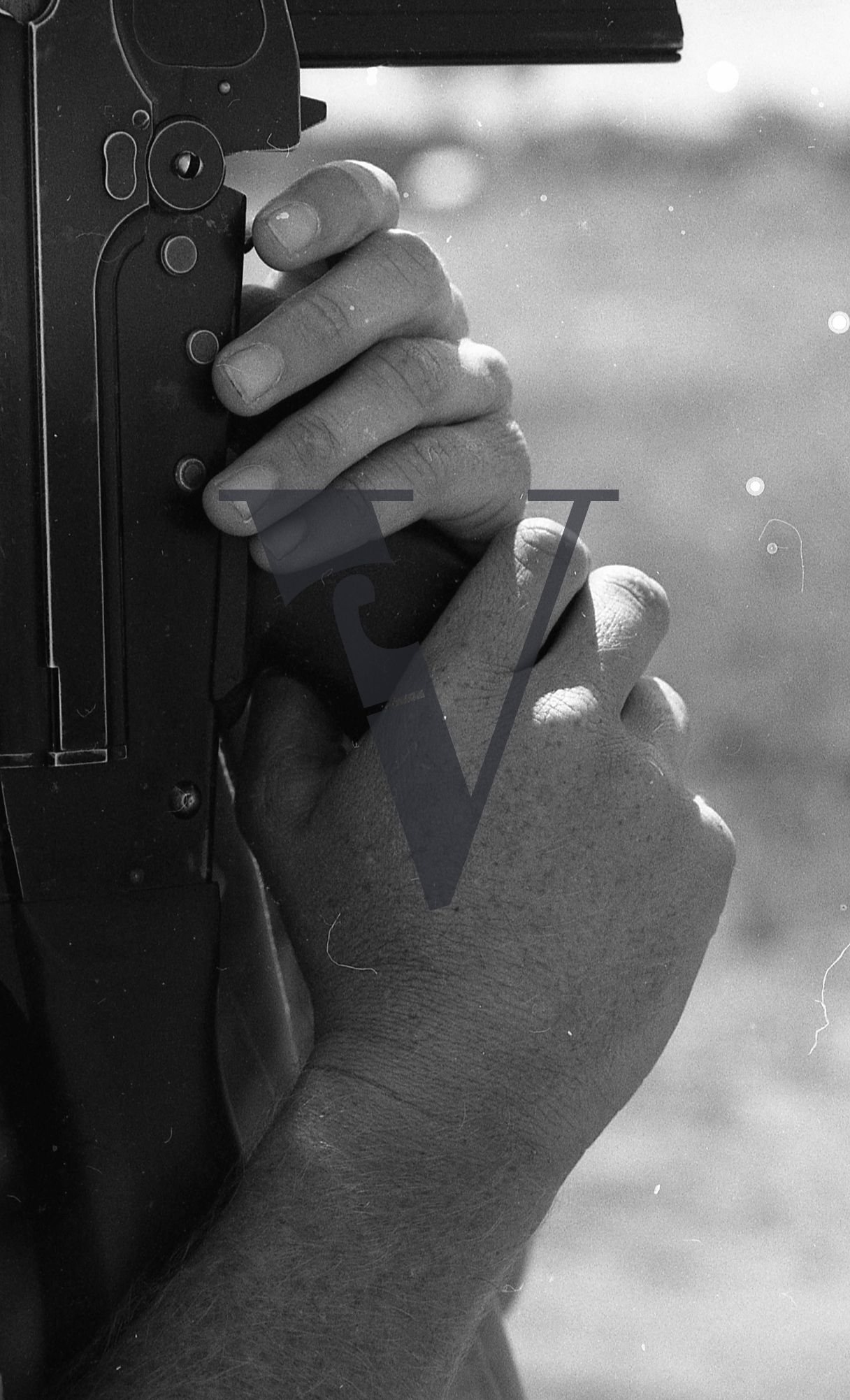 Rhodesia, “protected village”, guard’s hands with rifle, portrait.