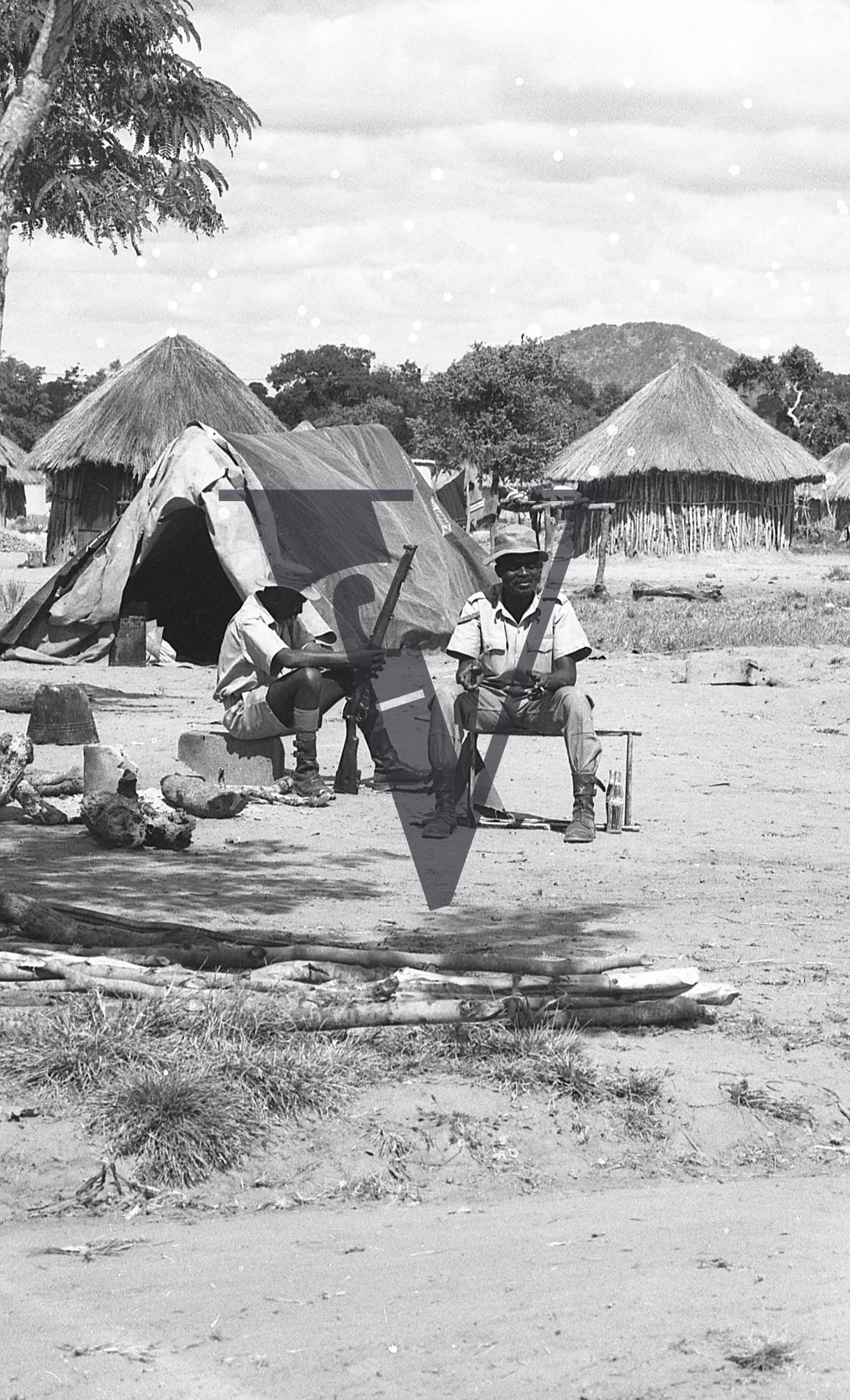 Rhodesia, “protected village”, armed guards relaxing.