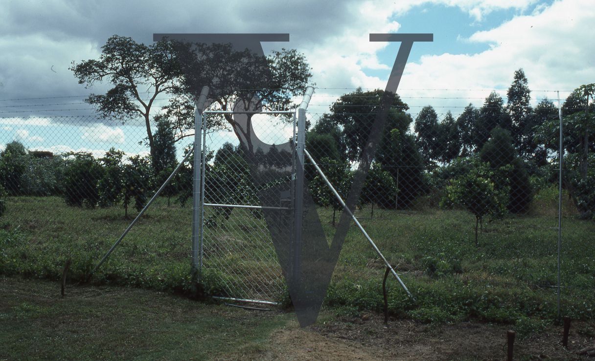 Rhodesia, farmland, barbed wire fence and gate.