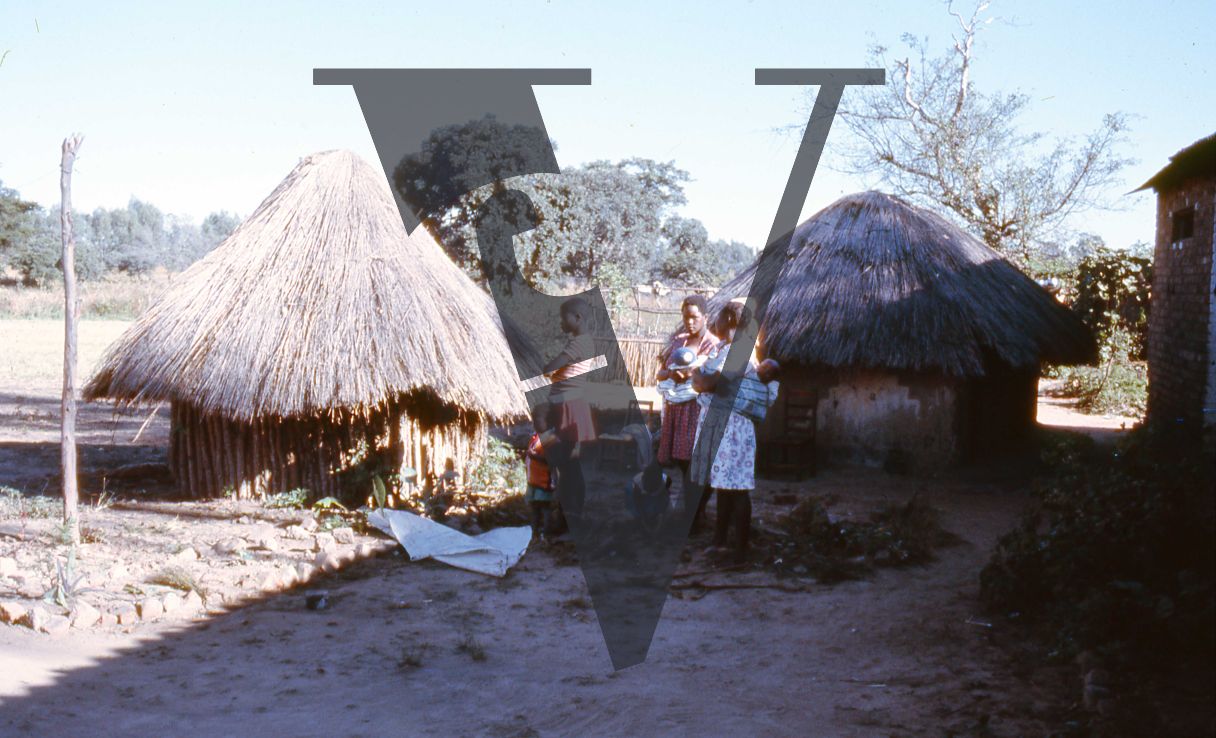 Rhodesia, tobacco farm, women and children, small huts.