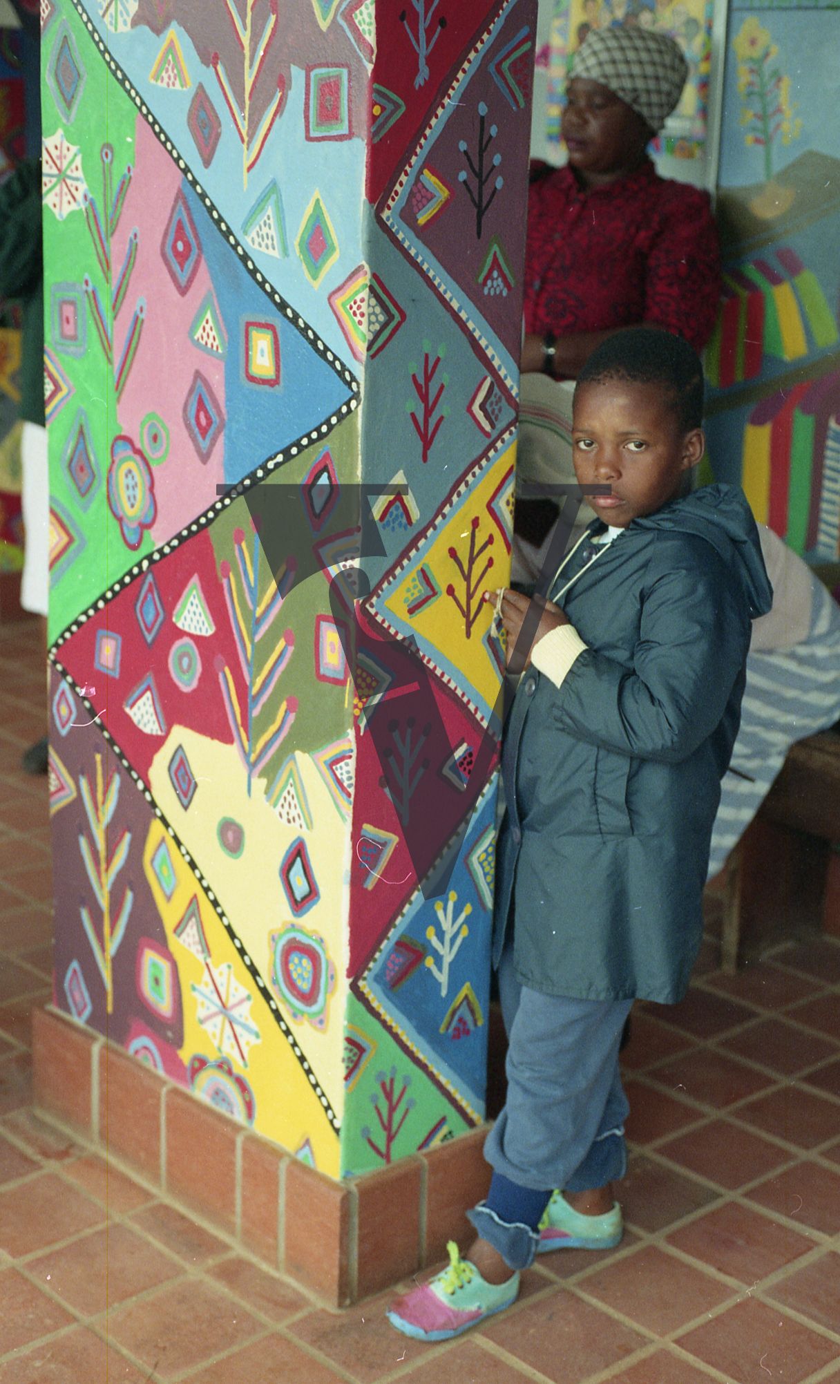 Sangoma, Zululand, boy standing next to murals at the Valley Trust, Botha's Hill.