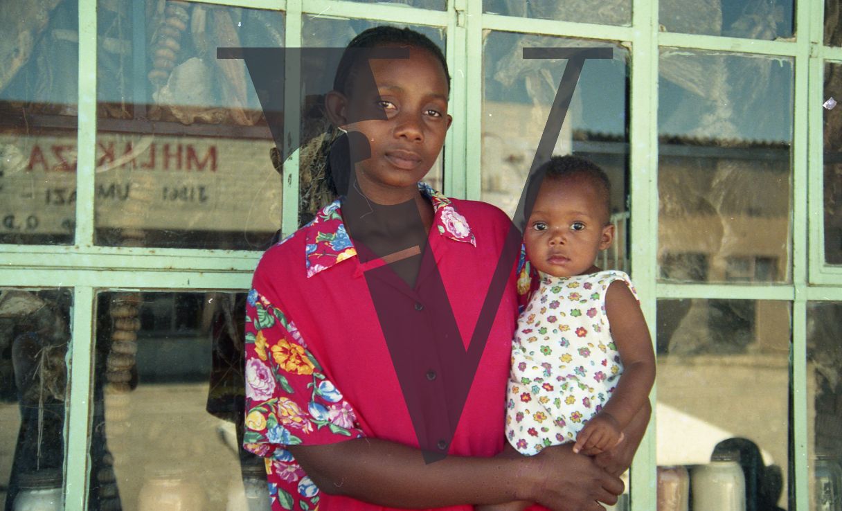 Sangoma, Zululand, Inyanga, woman holding child, portrait.