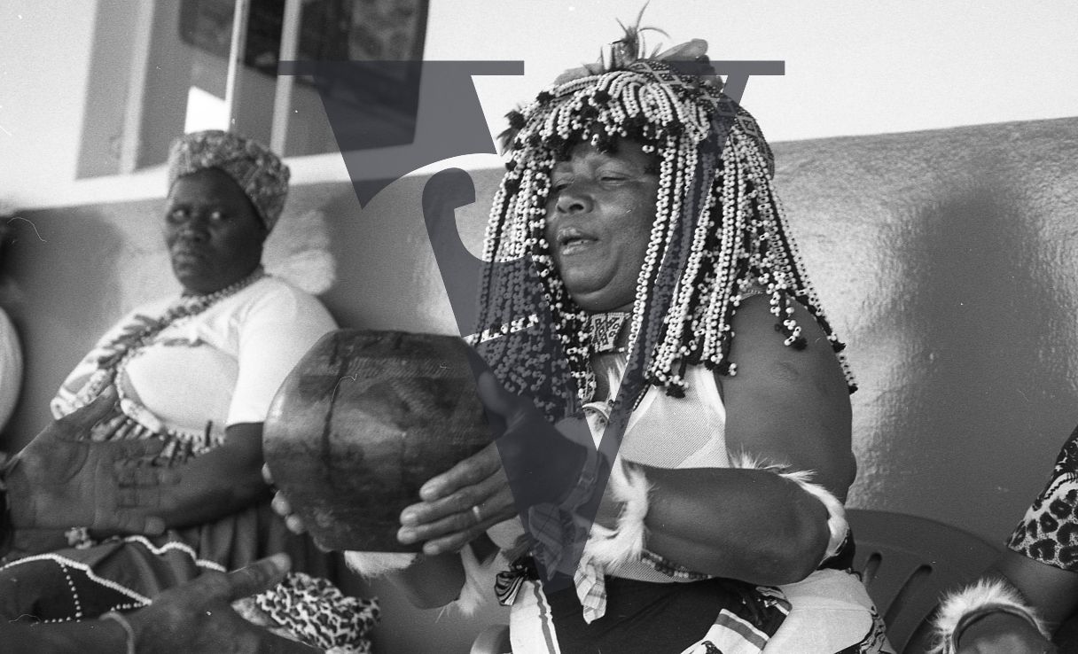 Sangoma, Zululand, Inyanga, holding up gourd.