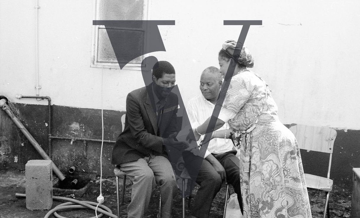 Sangoma, Zululand, Inyanga, Koloko with patients, outside.