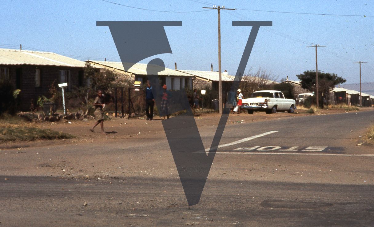 South Africa, Soweto, township, road junction, people, cars, low angle.