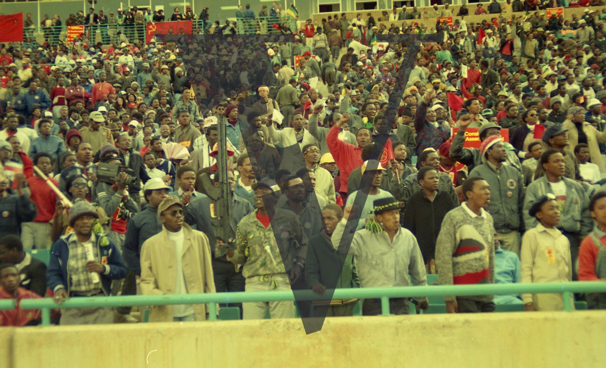 South Africa, Johannesburg, FNB Stadium, ANC rally, crowd, man with rifle.