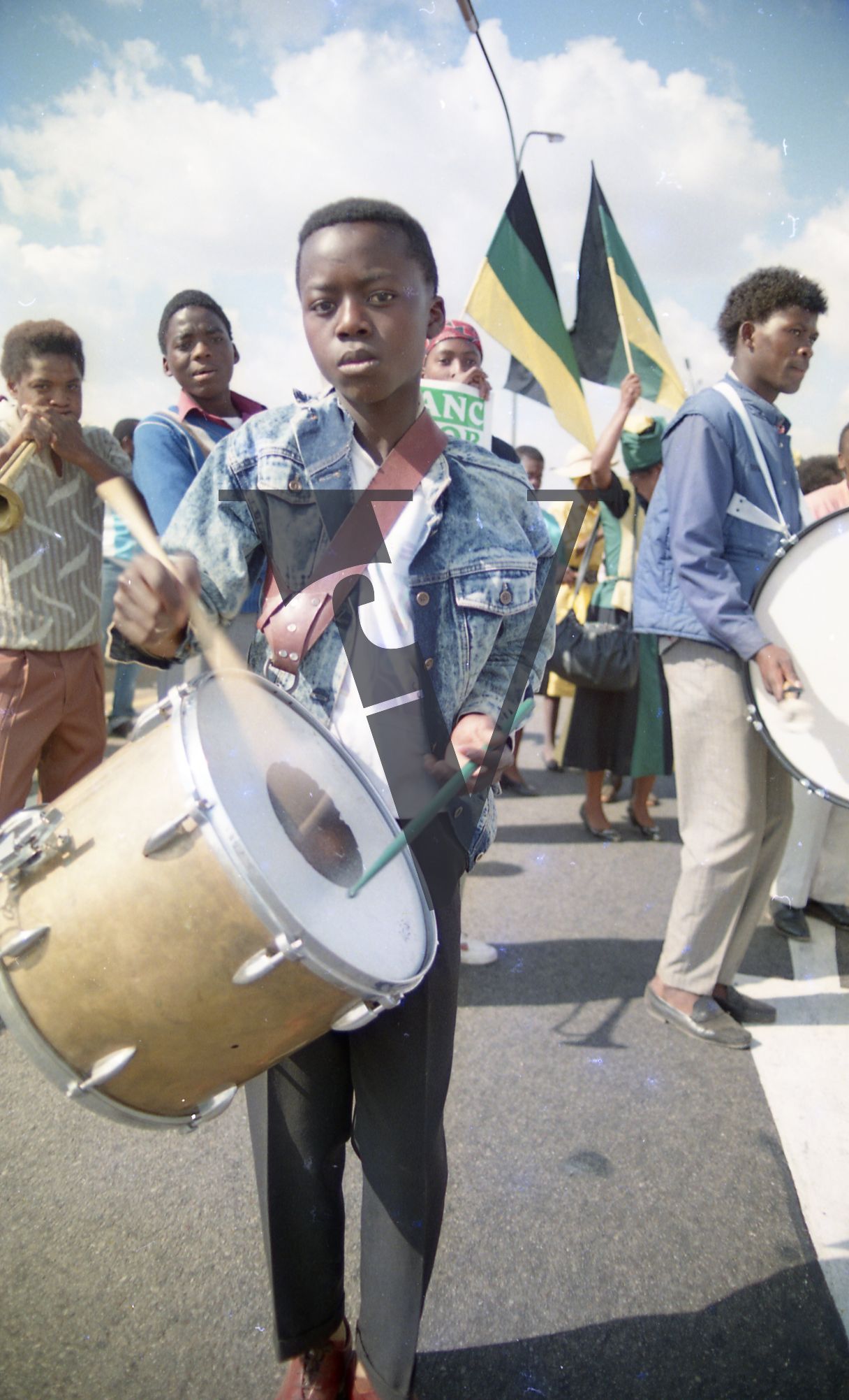 South Africa, ANC parade, boy drumming, flags.