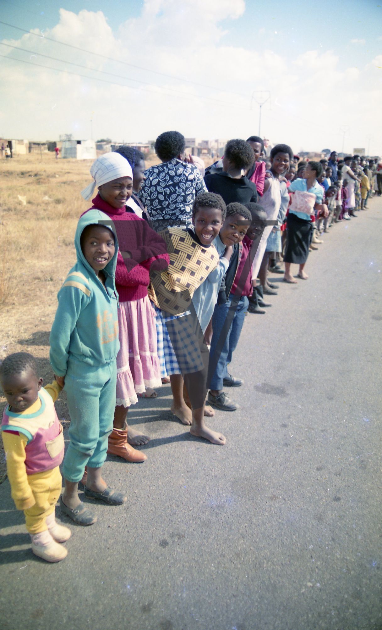 South Africa, line of parade spectators, women, children.