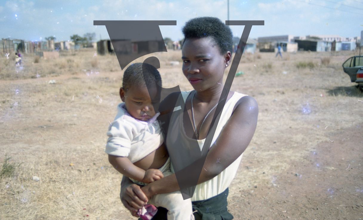 South Africa, shanty town, woman, infant, portrait.