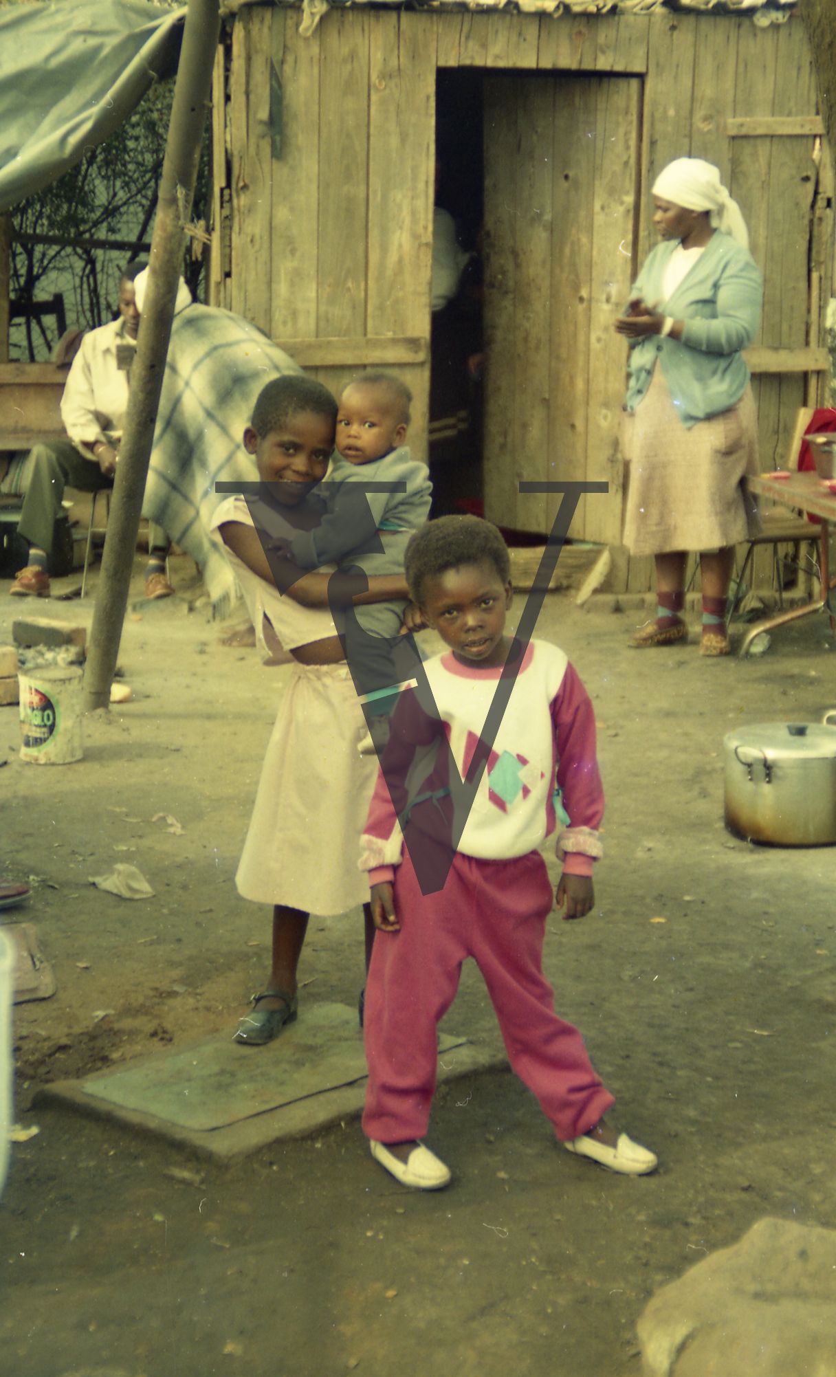 South Africa, shanty town, children, young girl carrying infant, portrait.