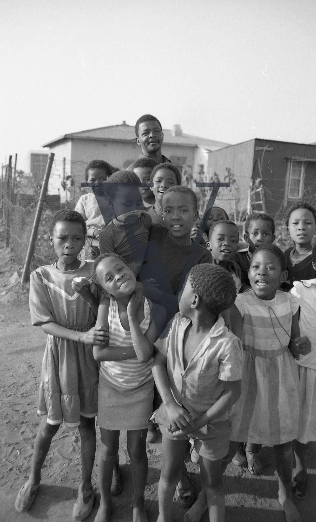 South Africa, township, man, children, group, smiling, portrait.