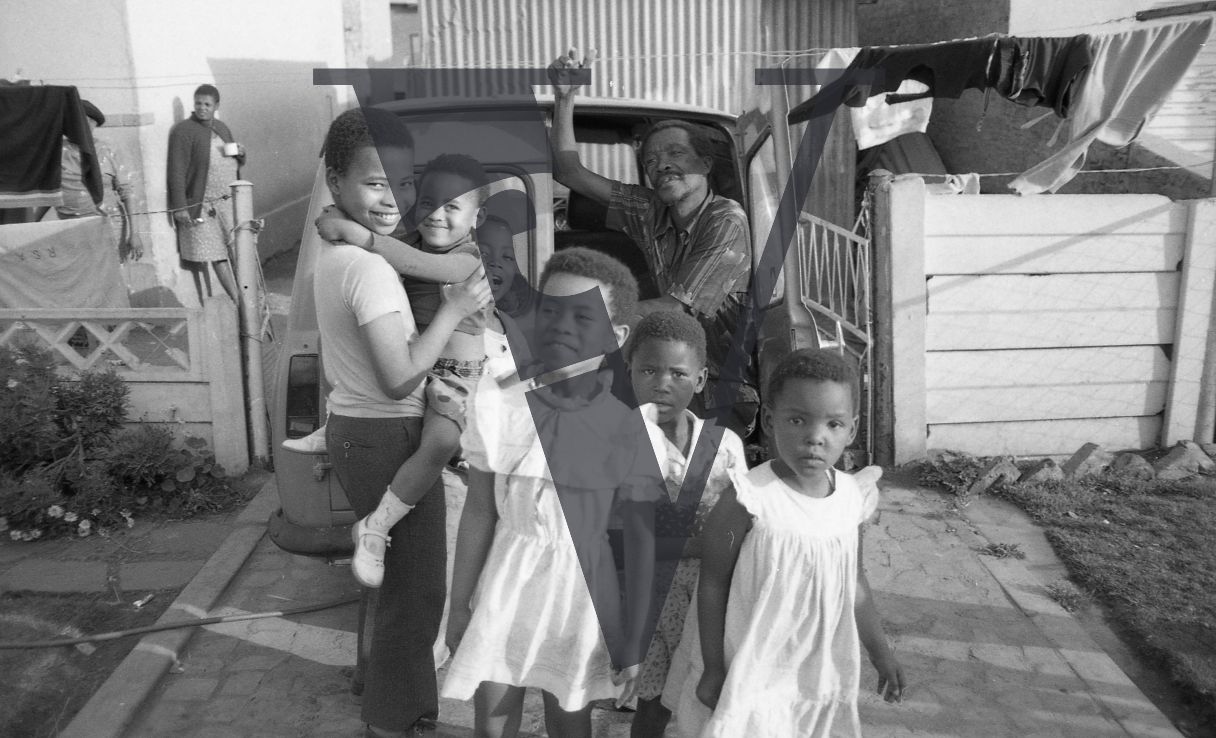 South Africa, township, family group, children, man, home, smiling.