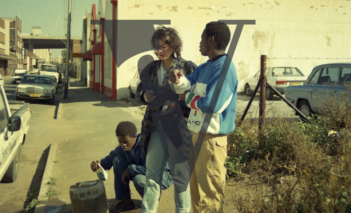 South Africa, street scene, Sara Blecher, film director, two men, cars.