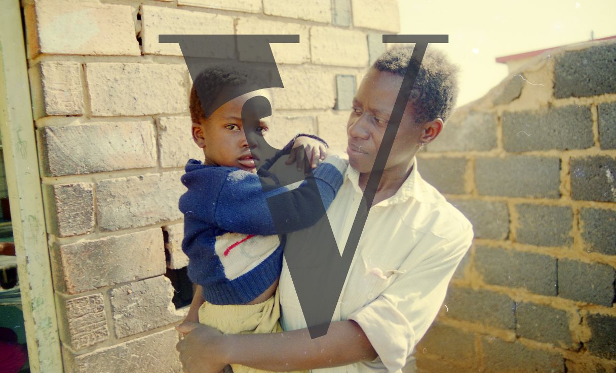 South Africa, Soweto, township, man holding child, portrait.
