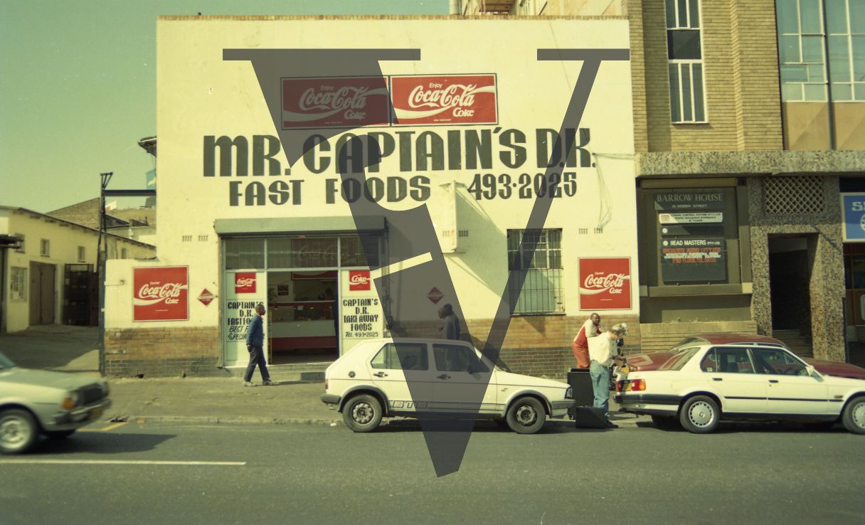 South Africa, street view, storefront, cars, pedestrians.