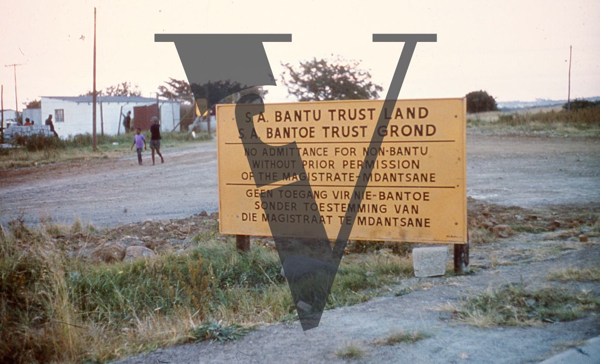 South Africa, South African Bantu Trust sign, children playing in background.